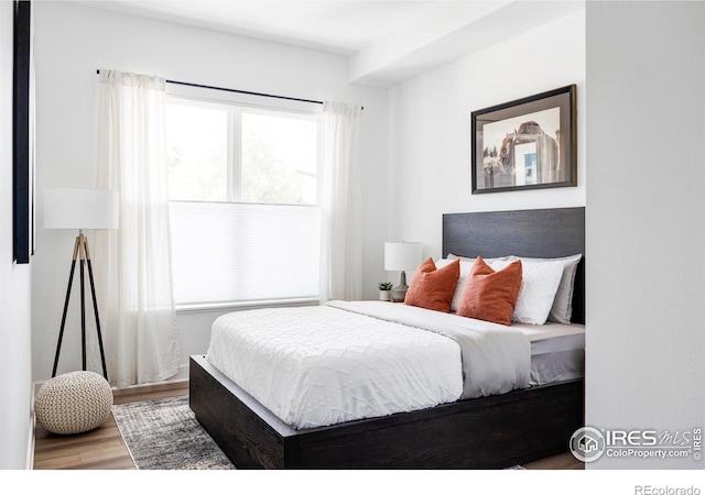 bedroom with wood finished floors