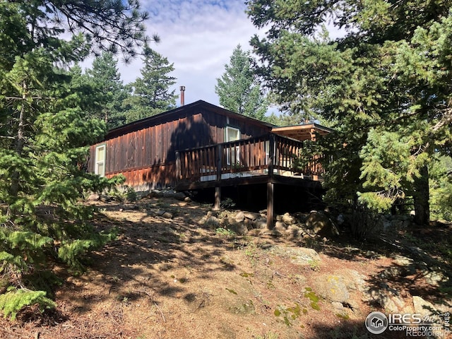 view of side of property with a wooden deck