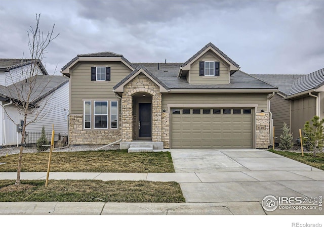3140 Newfound Lake Rd, Berthoud, CO 80513 - craftsman-style home featuring fence, stone siding, and concrete driveway