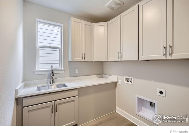 3140 Newfound Lake Rd, Berthoud, CO 80513 - laundry area with a sink, washer hookup, electric dryer hookup, light wood-type flooring, and cabinet space