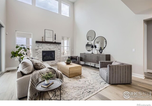 3140 Newfound Lake Rd, Berthoud, CO 80513 - living area featuring a high ceiling, a fireplace, and wood finished floors