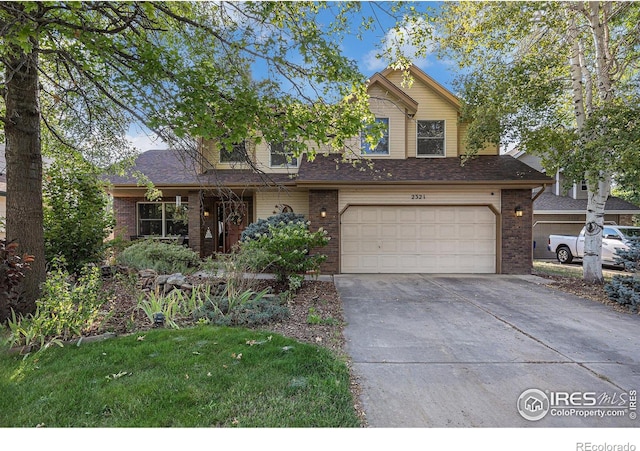 view of front of property featuring a garage and a front yard