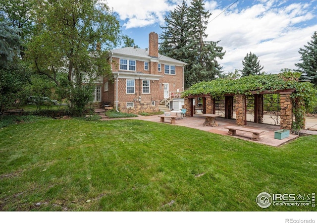 back of house with a lawn and a patio area