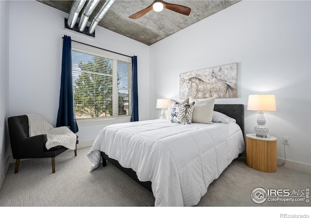 carpeted bedroom with ceiling fan and baseboards