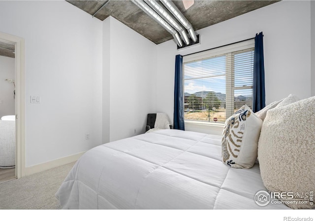 bedroom featuring carpet and baseboards