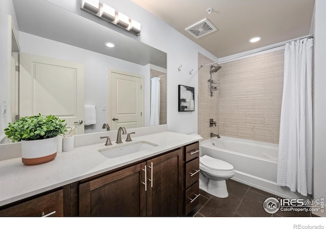 bathroom with toilet, shower / tub combo, vanity, visible vents, and tile patterned floors