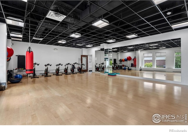 workout area with wood finished floors and visible vents