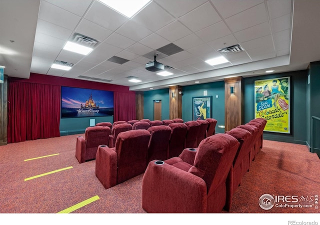 carpeted cinema featuring a paneled ceiling and visible vents