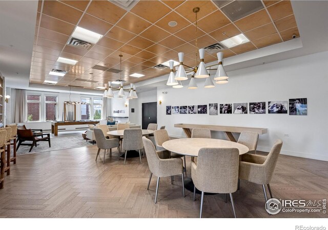 dining room with a drop ceiling, visible vents, and baseboards