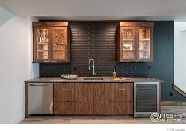 bar featuring tasteful backsplash, wine cooler, sink, and stainless steel dishwasher