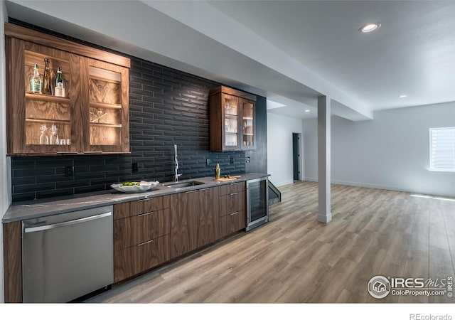 bar with tasteful backsplash, wine cooler, stainless steel dishwasher, and light hardwood / wood-style floors