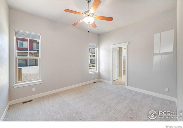 unfurnished room featuring ceiling fan and light colored carpet