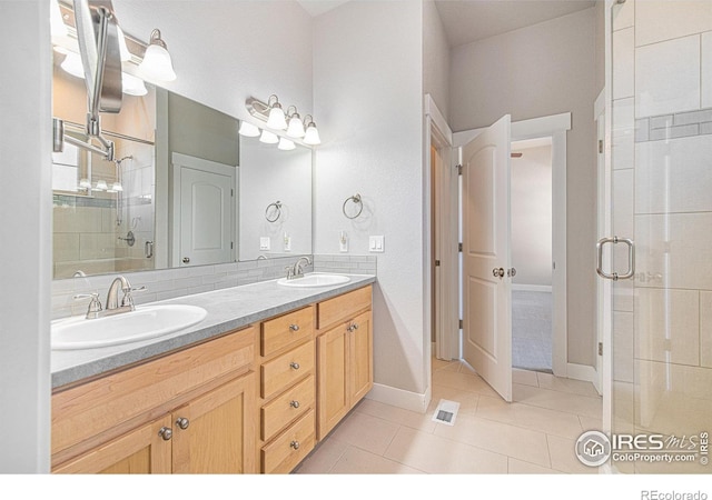 bathroom with vanity, a shower with shower door, and tile patterned flooring