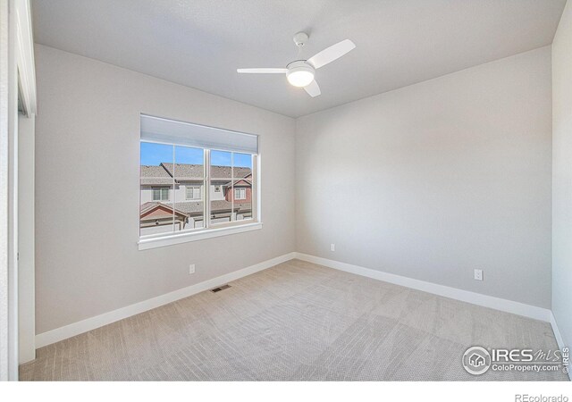 carpeted empty room with ceiling fan