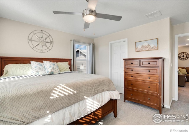 bedroom featuring ceiling fan and light carpet