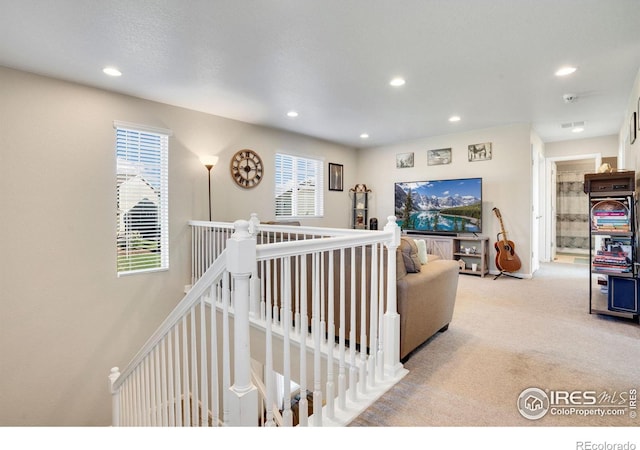 carpeted living room with a healthy amount of sunlight