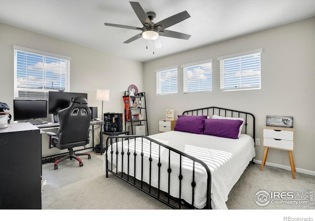 bedroom featuring ceiling fan and light carpet