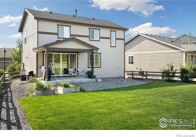 rear view of property featuring a lawn, a patio, and cooling unit