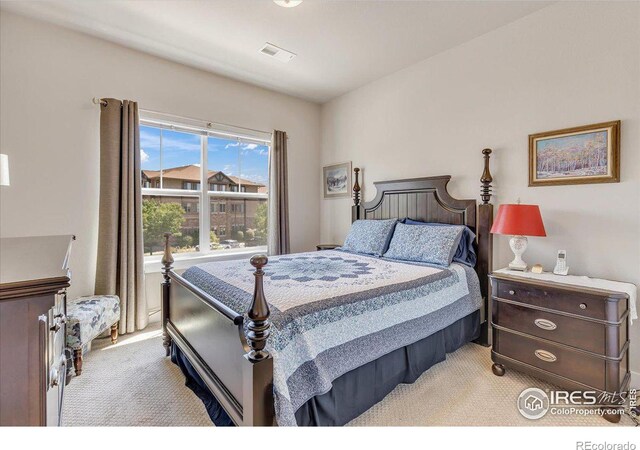 bedroom featuring light colored carpet