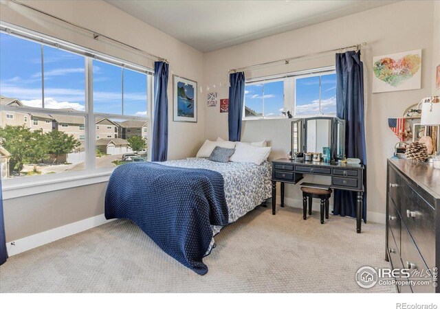 bedroom featuring light colored carpet