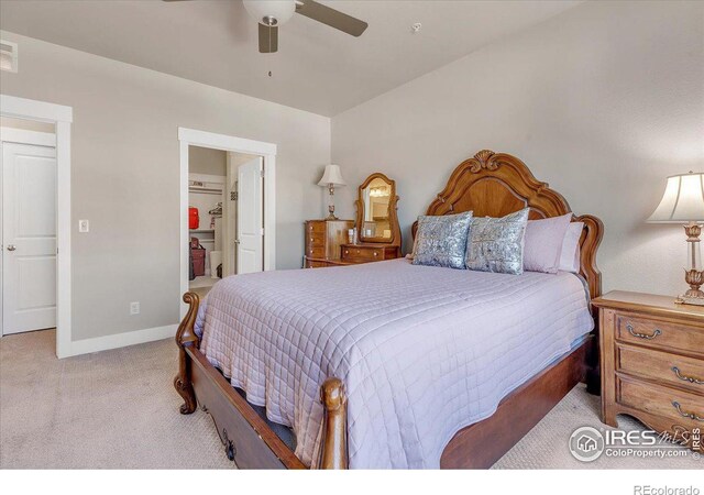 carpeted bedroom with ceiling fan and connected bathroom