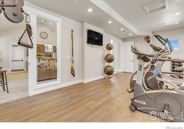 workout room with light hardwood / wood-style floors