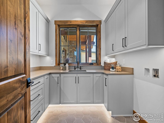 interior space featuring washer hookup, a sink, and cabinet space