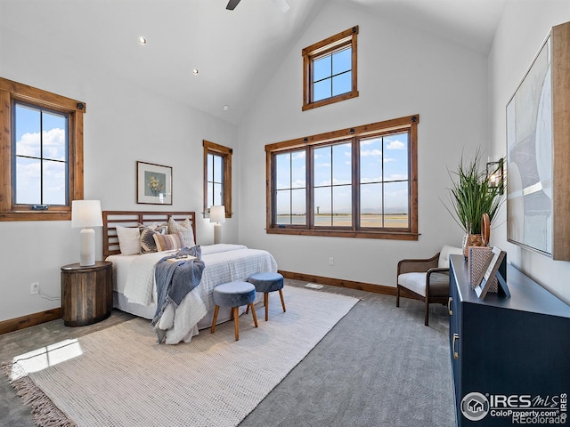 carpeted bedroom featuring high vaulted ceiling, ceiling fan, and baseboards