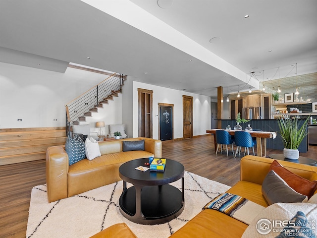 living room featuring wainscoting, stairway, and wood finished floors