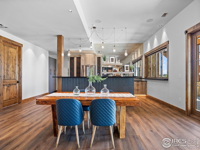 dining space with baseboards, wood finished floors, and recessed lighting