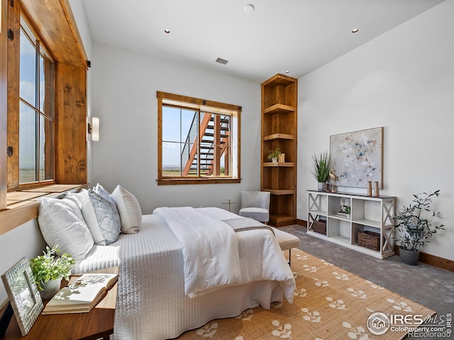 carpeted bedroom featuring recessed lighting, visible vents, and baseboards