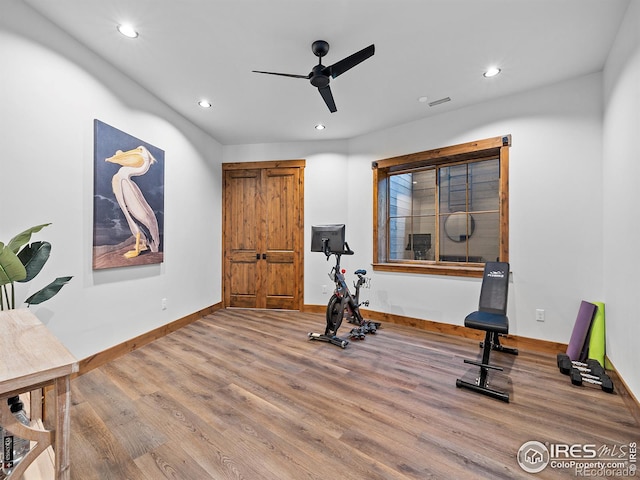 workout area featuring recessed lighting, ceiling fan, baseboards, and wood finished floors