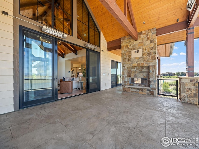 view of patio featuring an outdoor stone fireplace