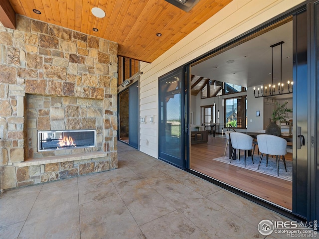 view of patio / terrace featuring a stone fireplace