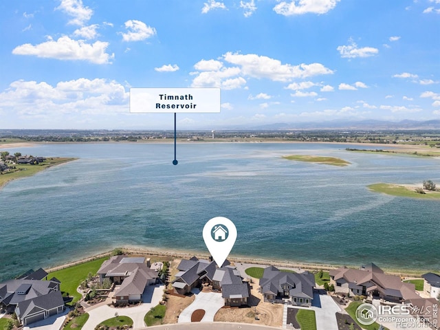 birds eye view of property with a water view and a residential view