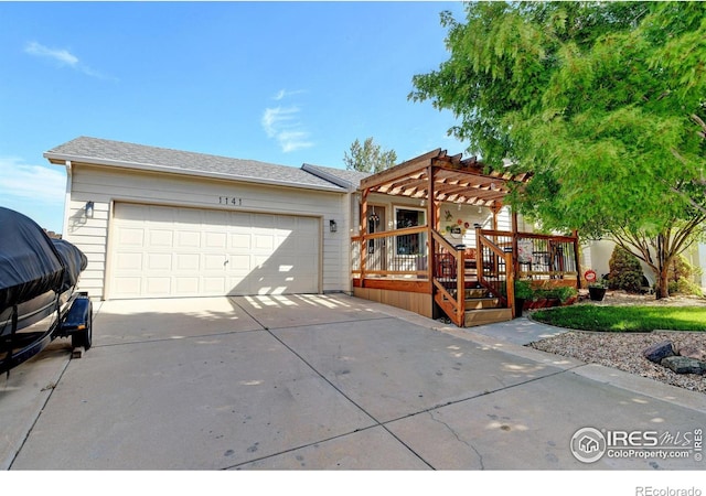 view of front of home with a pergola, a wooden deck, and a garage