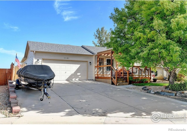 view of front of home featuring a garage and a wooden deck