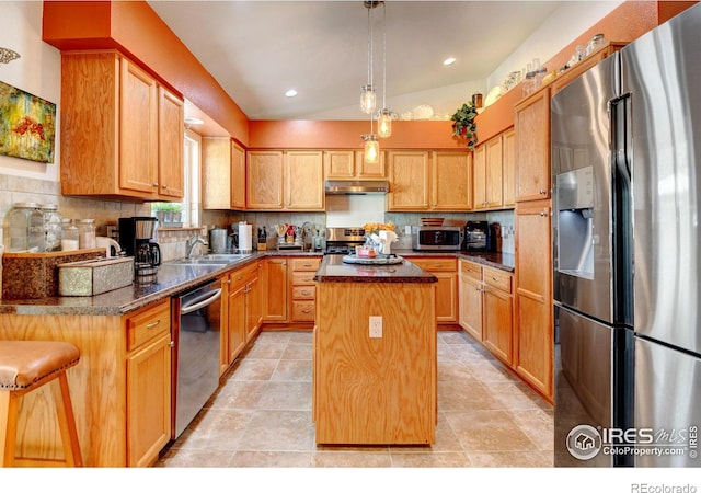 kitchen with backsplash, a center island, vaulted ceiling, stainless steel appliances, and sink