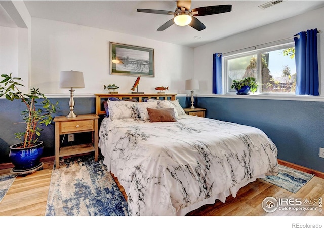 bedroom with hardwood / wood-style floors and ceiling fan