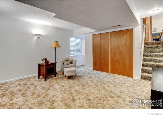 living area with a textured ceiling and carpet flooring