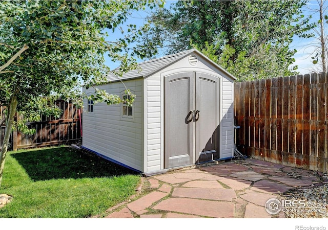 view of outbuilding featuring a yard