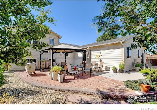 rear view of property with a patio and a gazebo