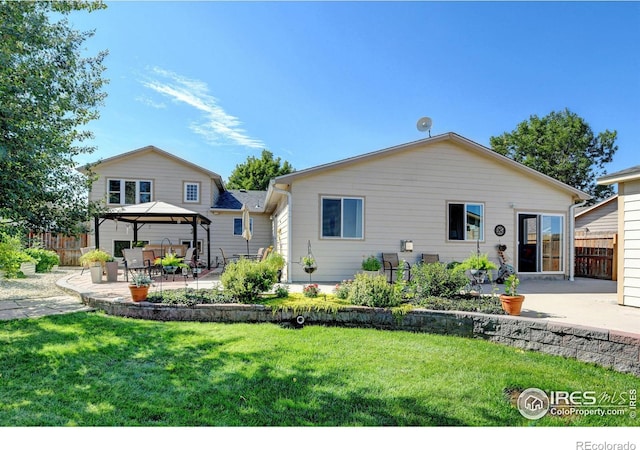 rear view of house with a patio area, a lawn, and a gazebo