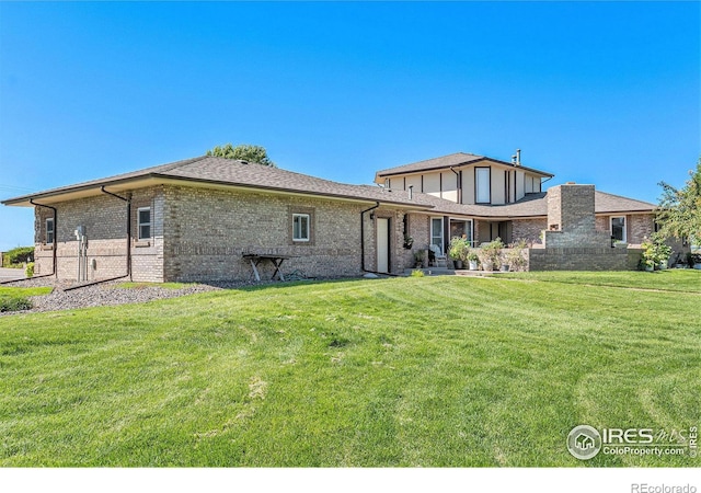 rear view of property with a lawn