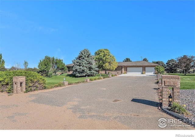 view of front of house with a garage and a front lawn