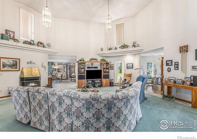 living room with an inviting chandelier and carpet floors