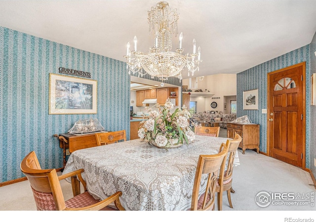 dining area with light colored carpet and a chandelier