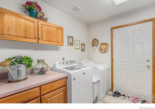 laundry room featuring cabinets and separate washer and dryer