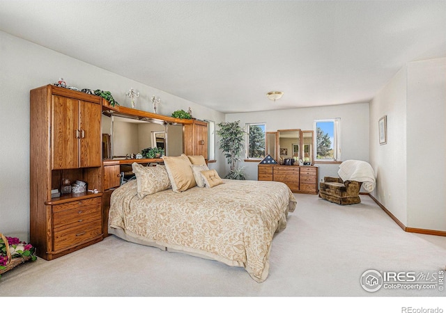 bedroom featuring light colored carpet