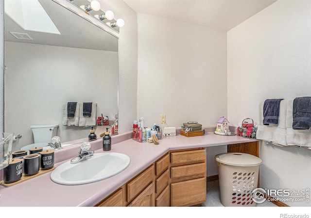 bathroom with vanity and toilet